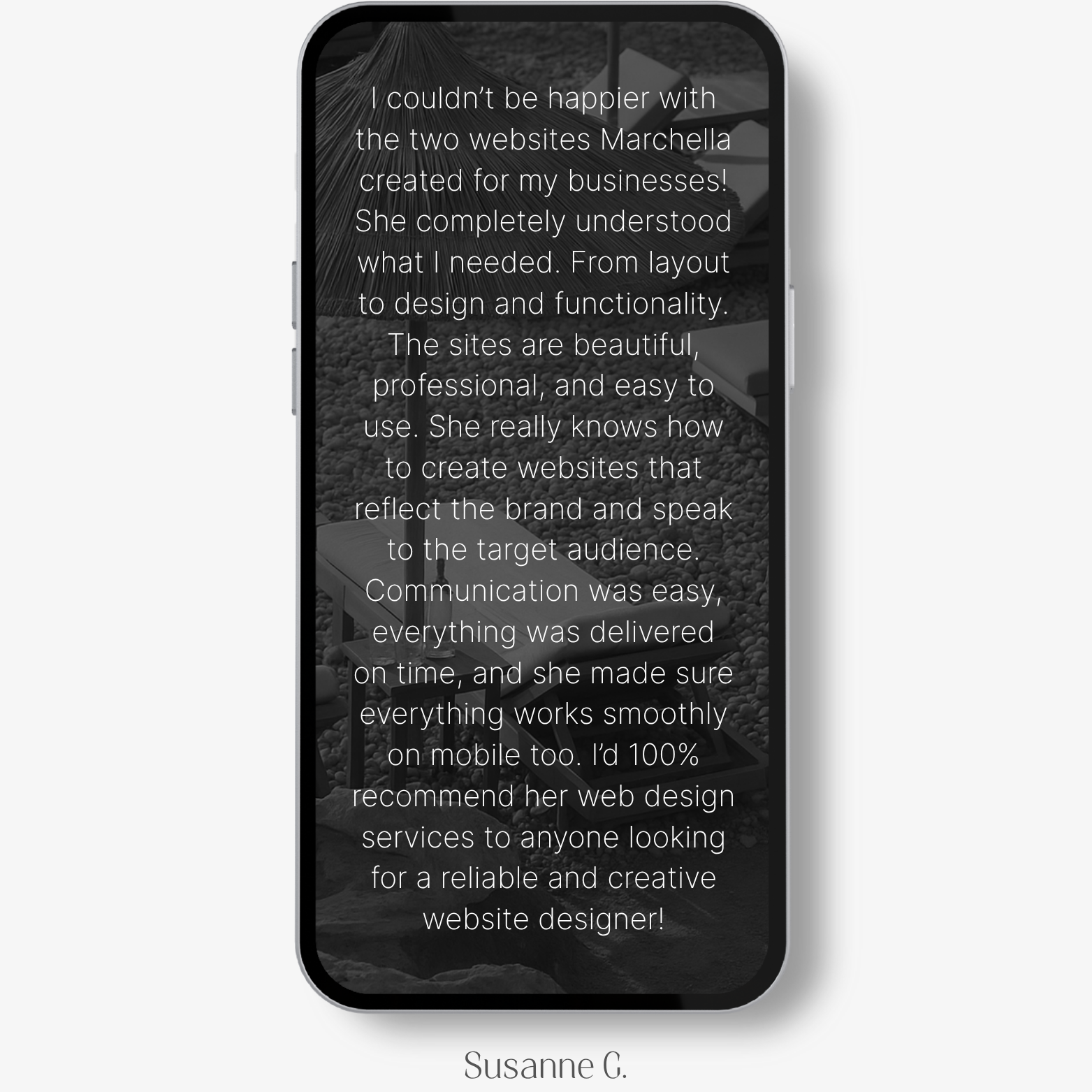 Client testimonial from Susanne G. shown on a smartphone mockup with a muted beach-style background. The review highlights Marchella Creative’s skill in crafting two custom websites with strong design and functionality, effective brand alignment, smooth mobile experience, and excellent communication. The tone is highly positive and confident.