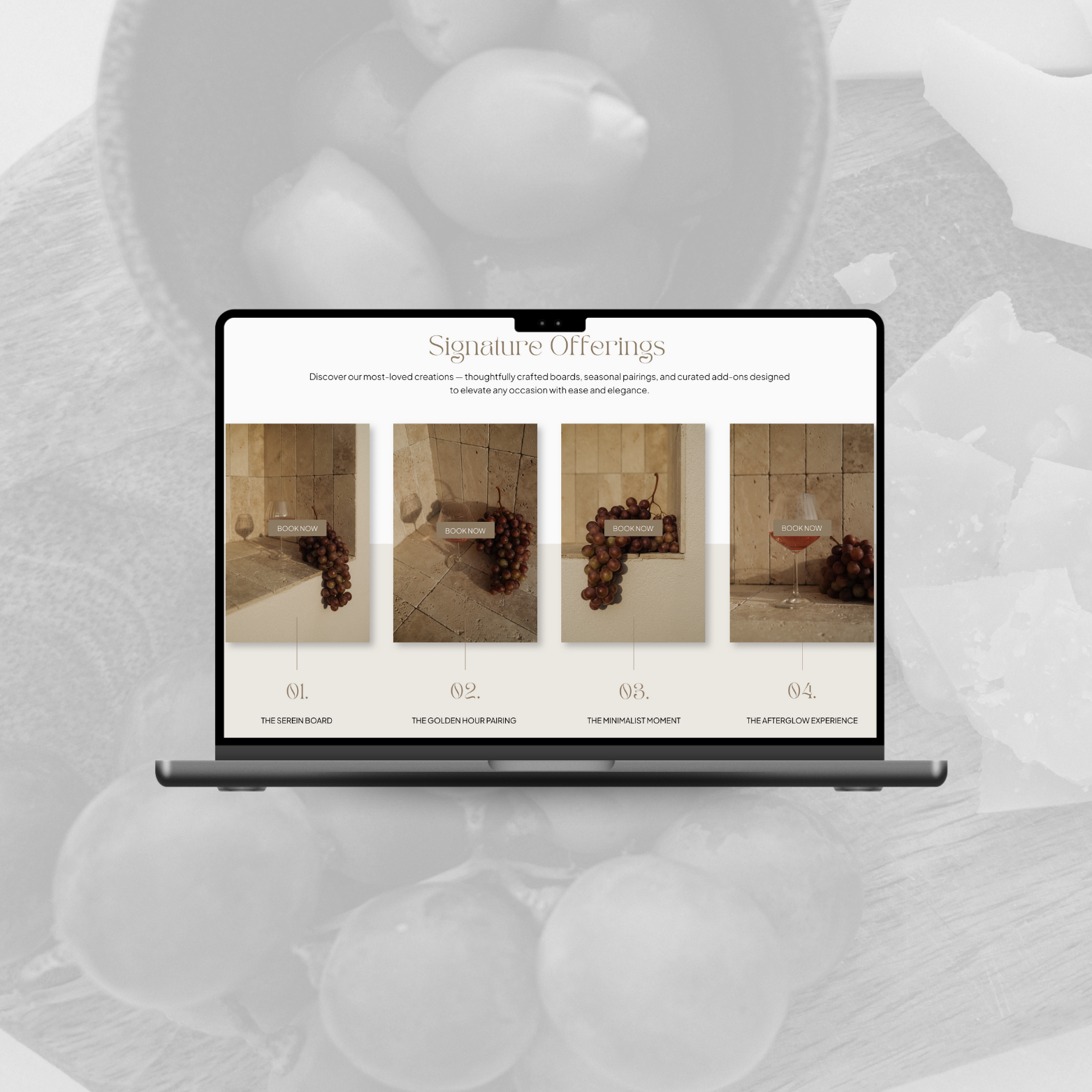 Laptop mockup displaying a Signature Offerings page with four curated food board options, featuring elegant grape pairings and minimalist stone backdrops.