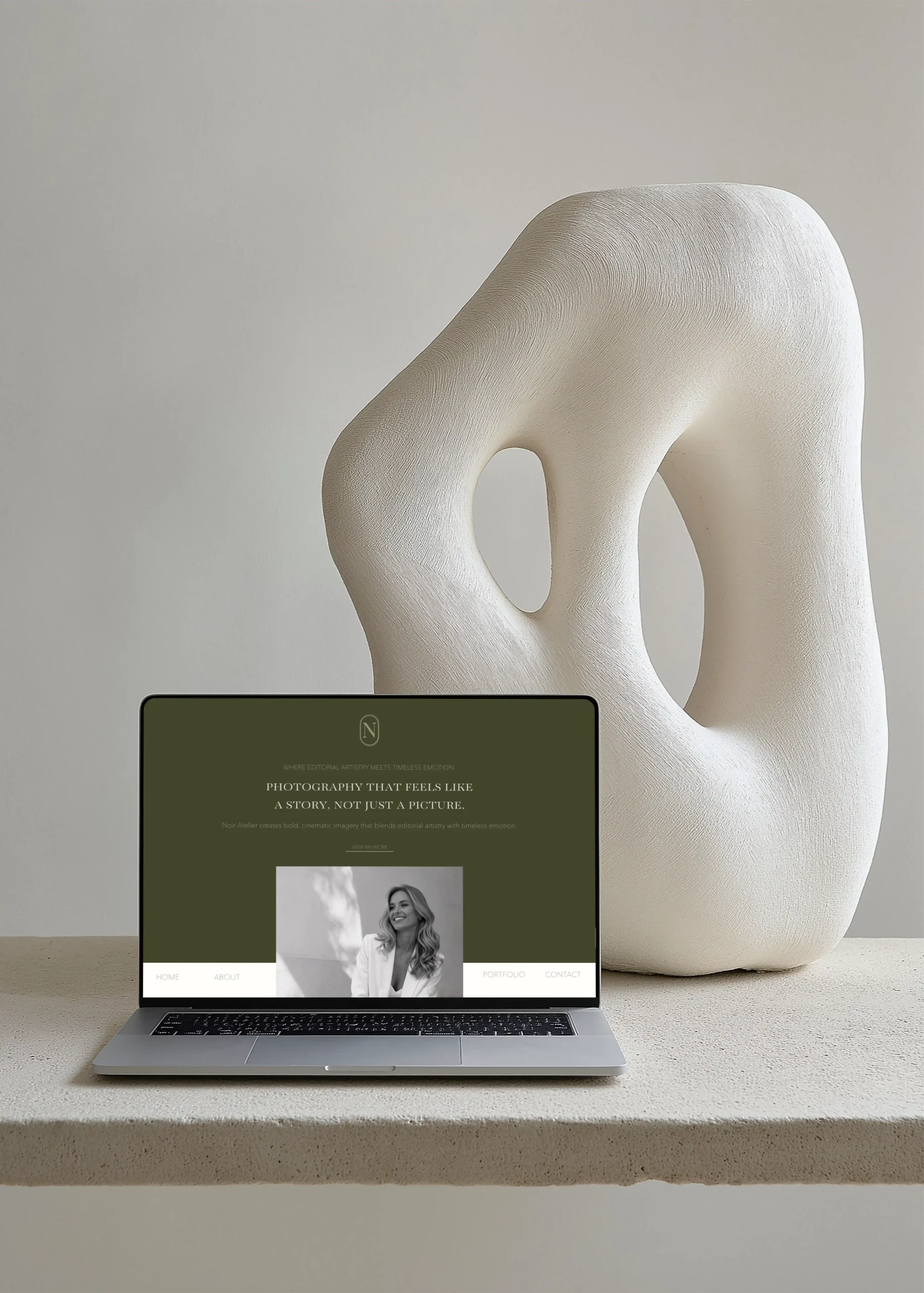 Custom professional web design by Marchella Creative, shown on a MacBook mockup with a minimalist, design-focused aesthetic.