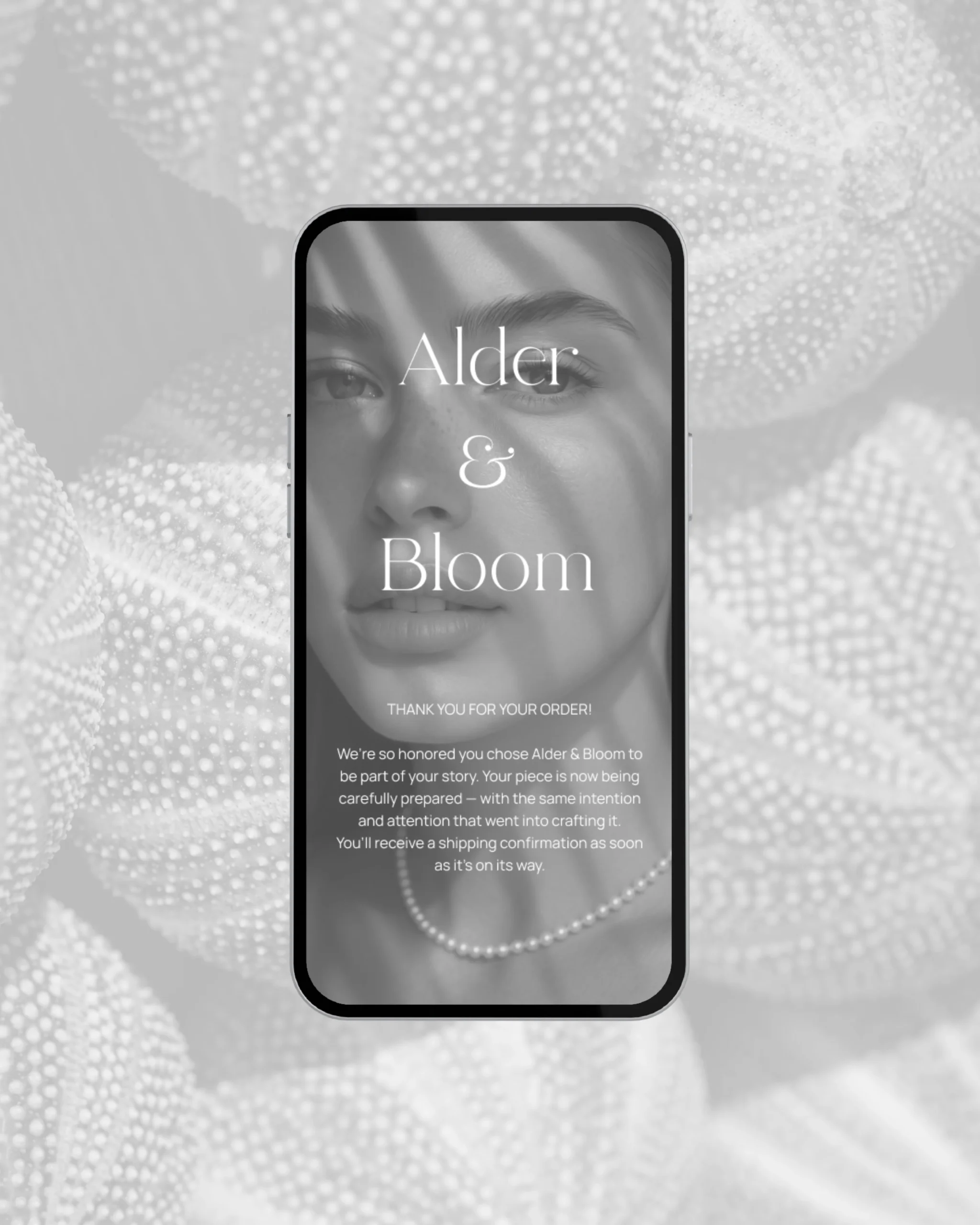 Mobile confirmation page mockup for Alder & Bloom order, featuring elegant serif typography over a portrait of a woman wearing pearls, with seashells in the background.
